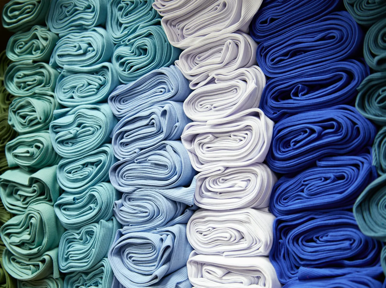 Stacked folds of soft fabric in natural tones