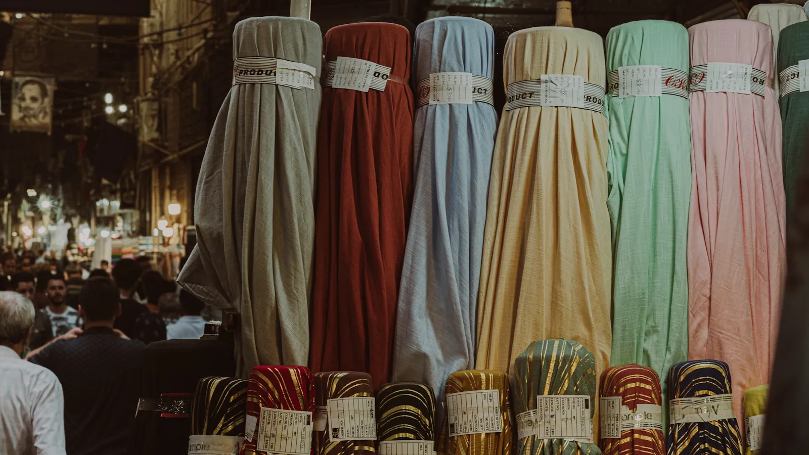 Colourful bolts of quilting fabric stacked in a shop