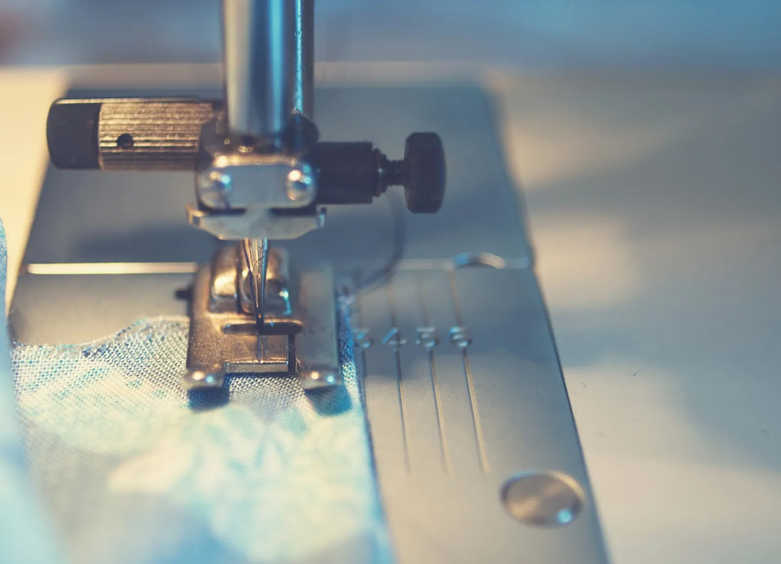Fabric being stitched under a quilting machine needle